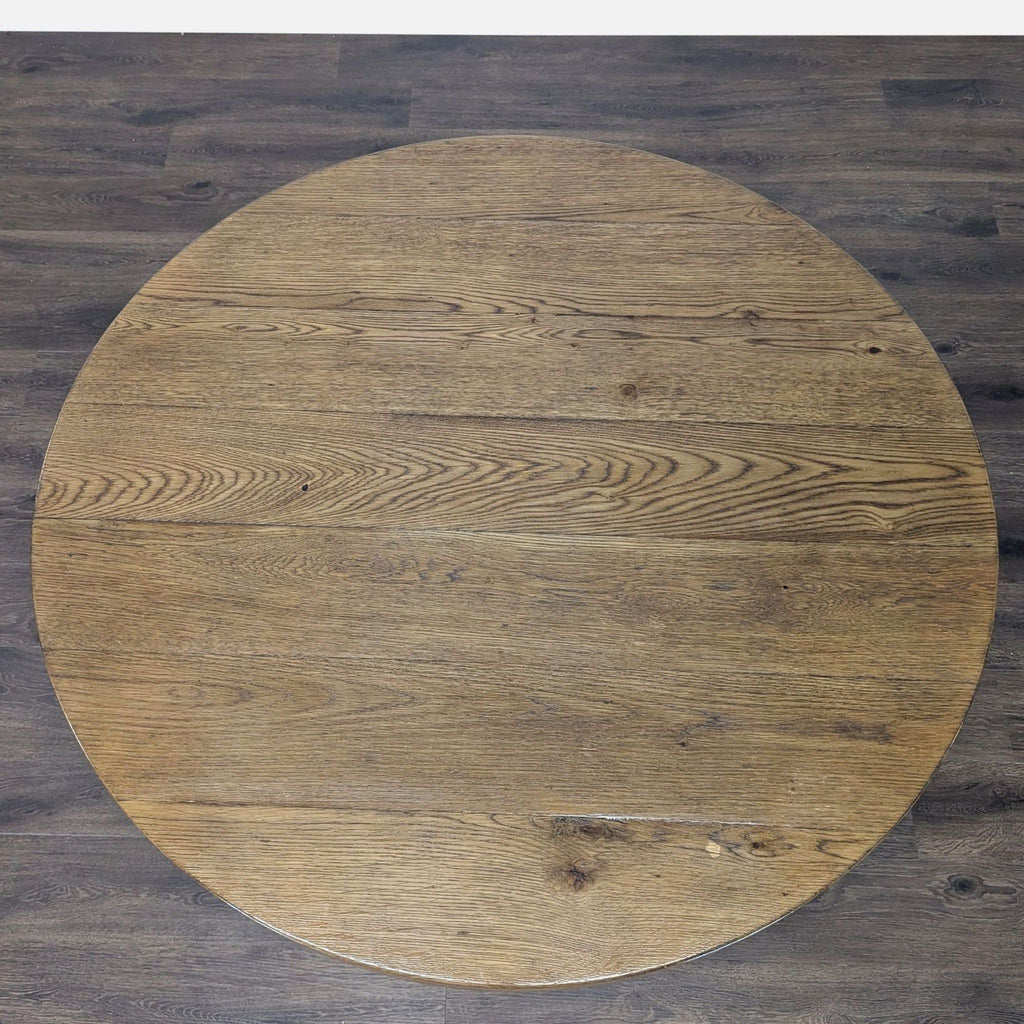2. Top view of a circular oak dining table by Restoration Hardware, highlighting the detailed wood grain finish.