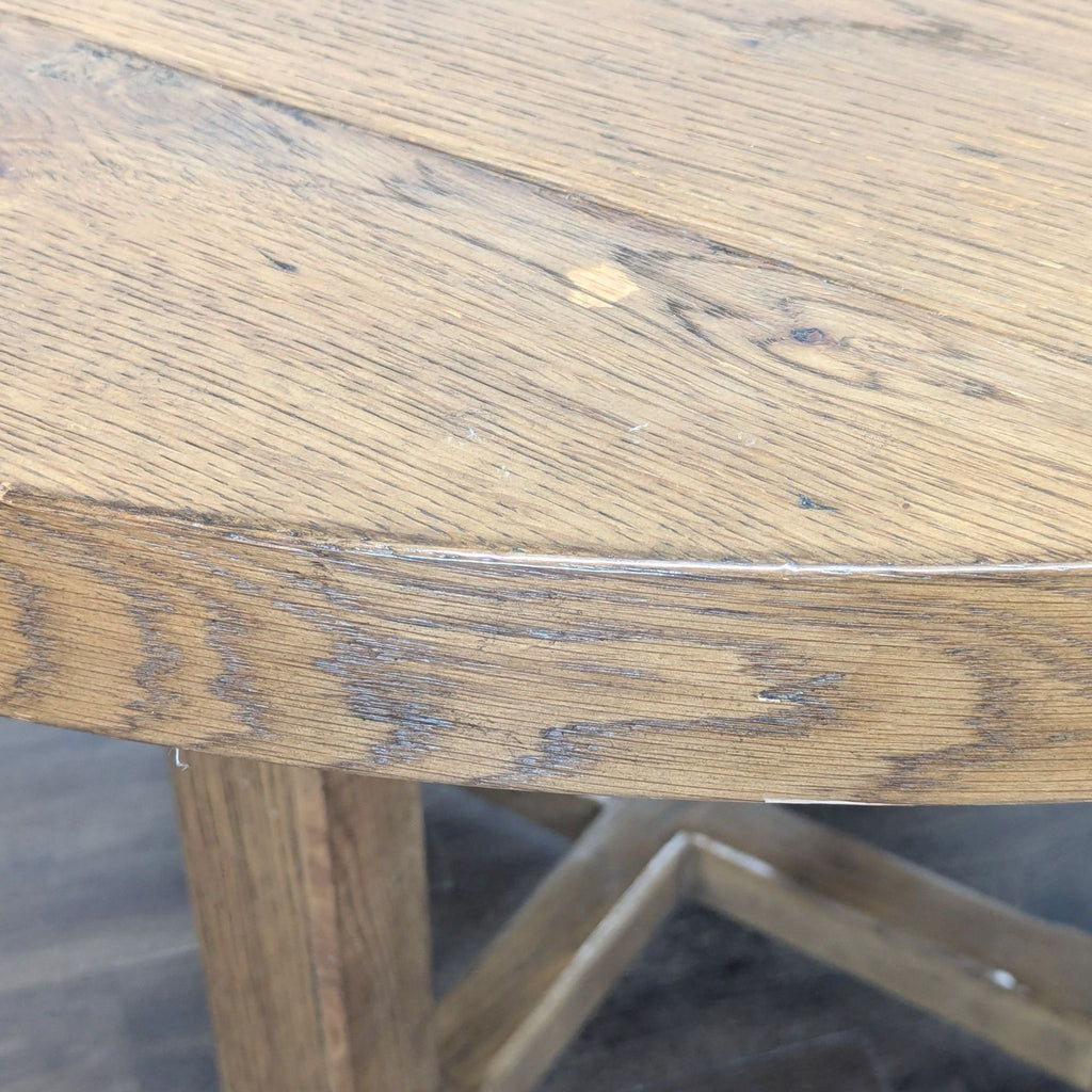 3. Close-up of the oak veneer dining table edge, showing hand-finished grain and warm patina from Restoration Hardware.