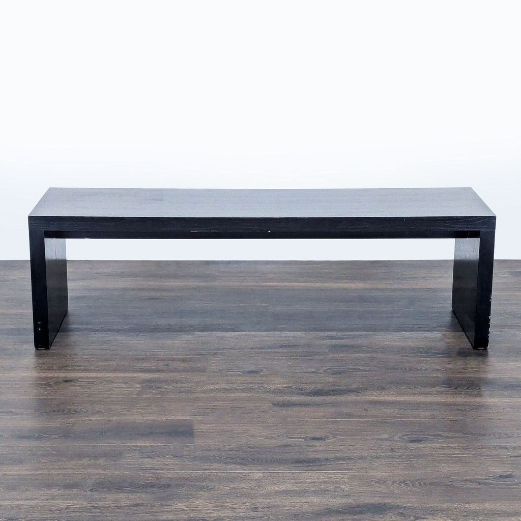 1. Black rectangular wooden bench from Reperch, shown on a dark floor, minimalist design, front view.