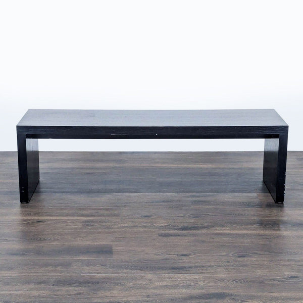 1. Black rectangular Reperch bench with clean lines, shown on a wooden floor from the front view.  