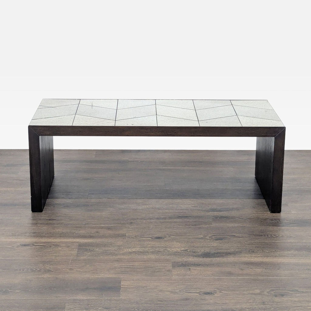 Full view of West Elm geometric tile bench with dark wood frame, placed on a wooden floor.