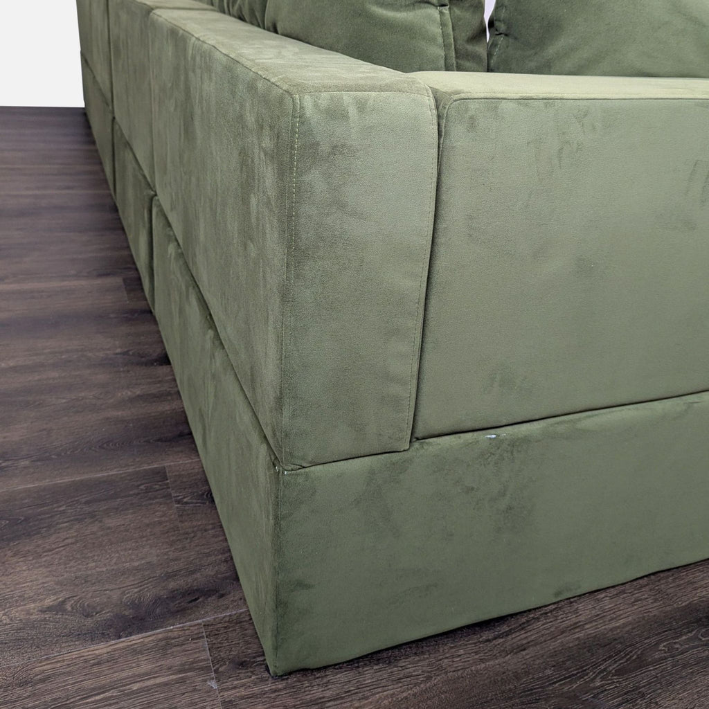 3. Close-up angle showing the soft olive velvet upholstery and modern stitching on the Albany Park sectional’s armrest.