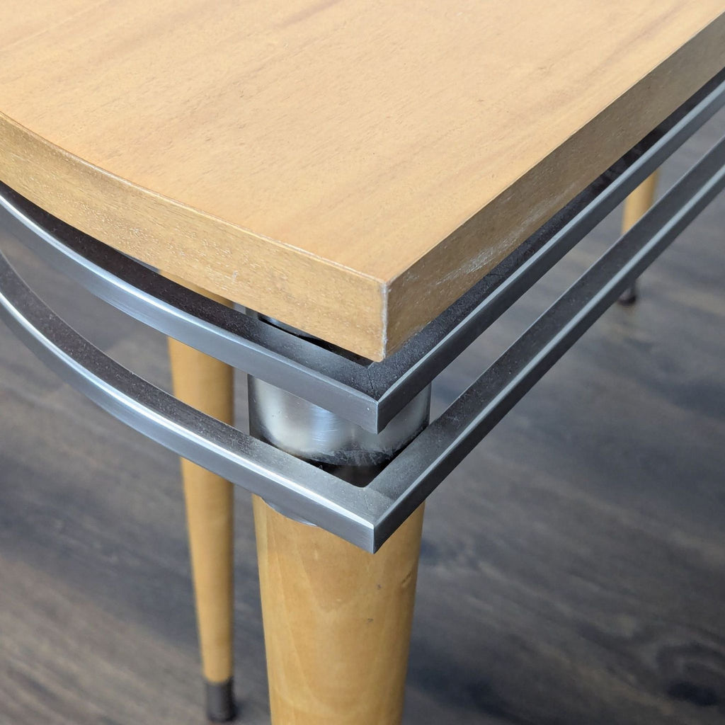 3. Close-up of Ethan Allen console table, highlighting wood top, metal trim, and tapered leg connection.
