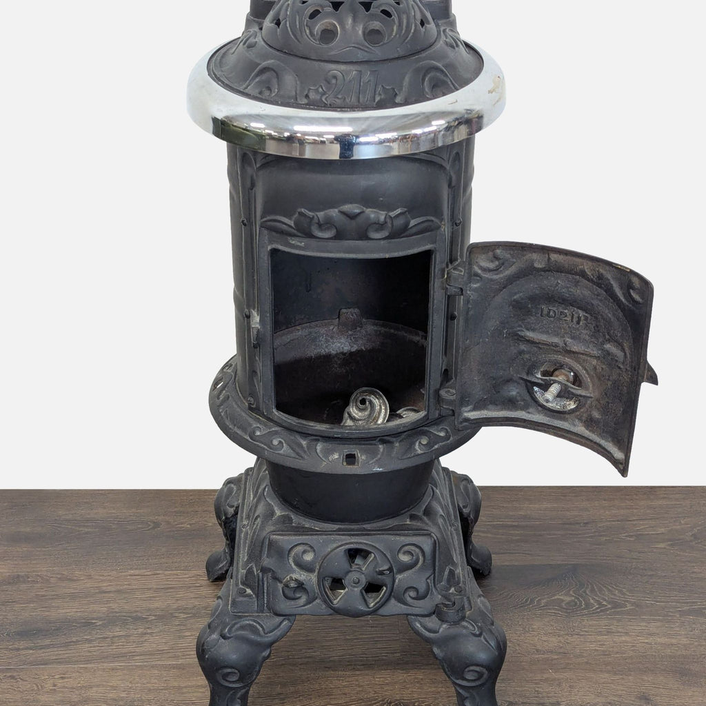 Close-up of the Reperch antique stove’s open front-loading door, showing its detailed craftsmanship and inner chamber.  