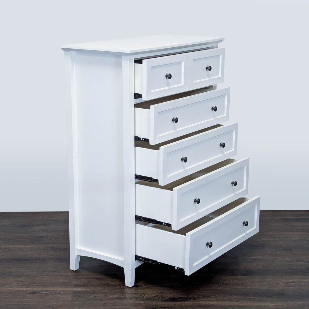 2. Side angle of Modus white dresser with all five drawers open, black knobs, and clean design.