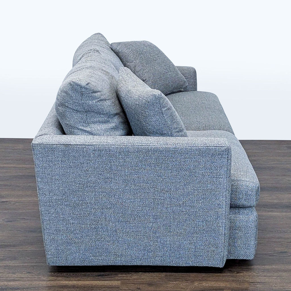 3. Side profile of a modern gray 3-seat Crate and Barrel sofa, highlighting the thick cushions and clean lines.