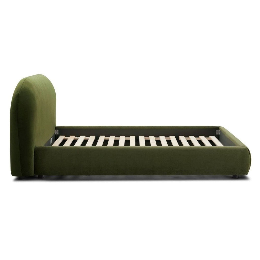 Side view of a green velvet Poly and Bark queen bed frame, featuring wooden slats and a curved headboard.