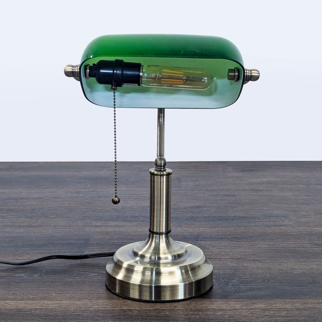 Elegant TorchStar lighting with sturdy brass base and green shade, perfect for office or reading spaces.