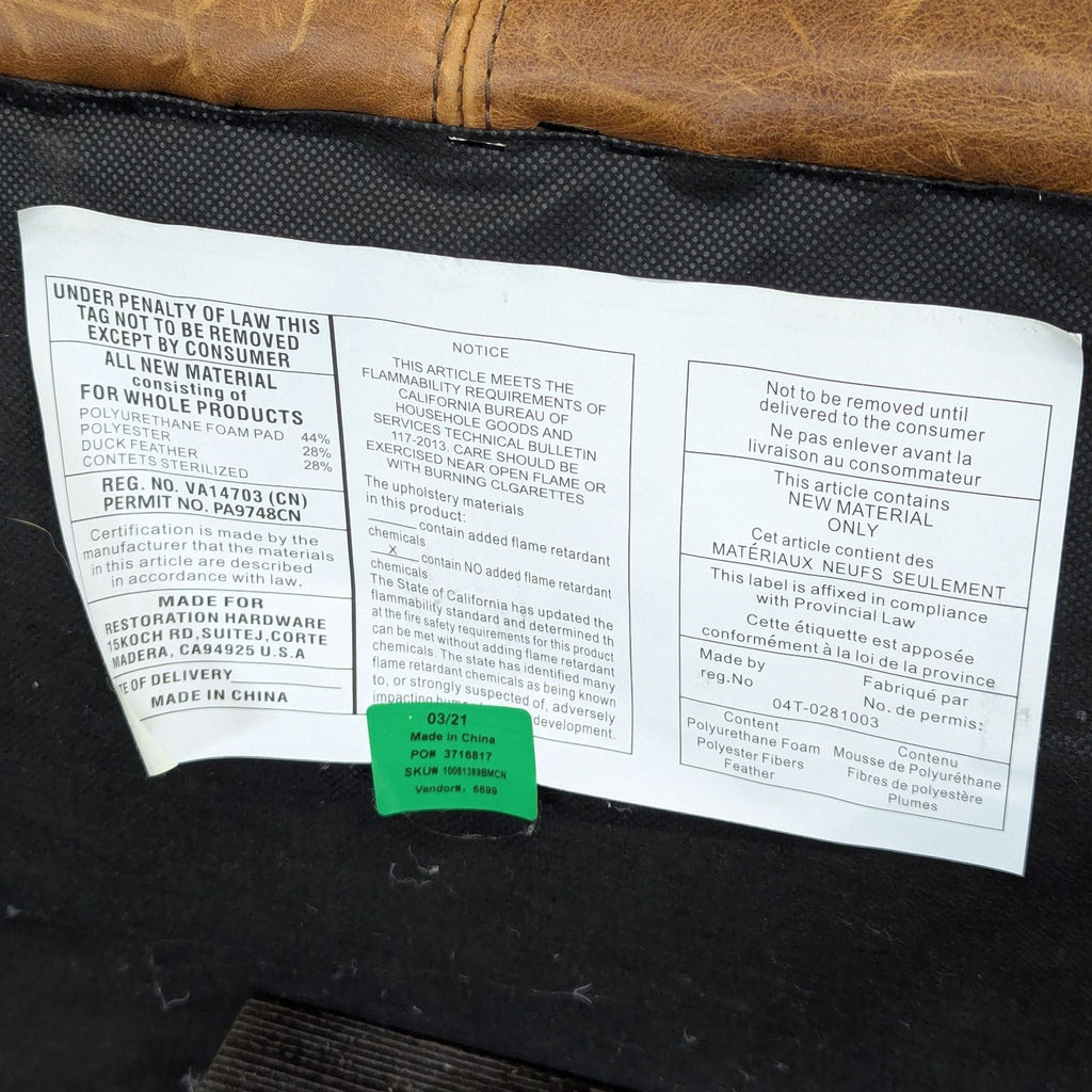 3. Manufacturer and material tag for a Restoration Hardware 3-seat sofa, displaying foam and feather contents.