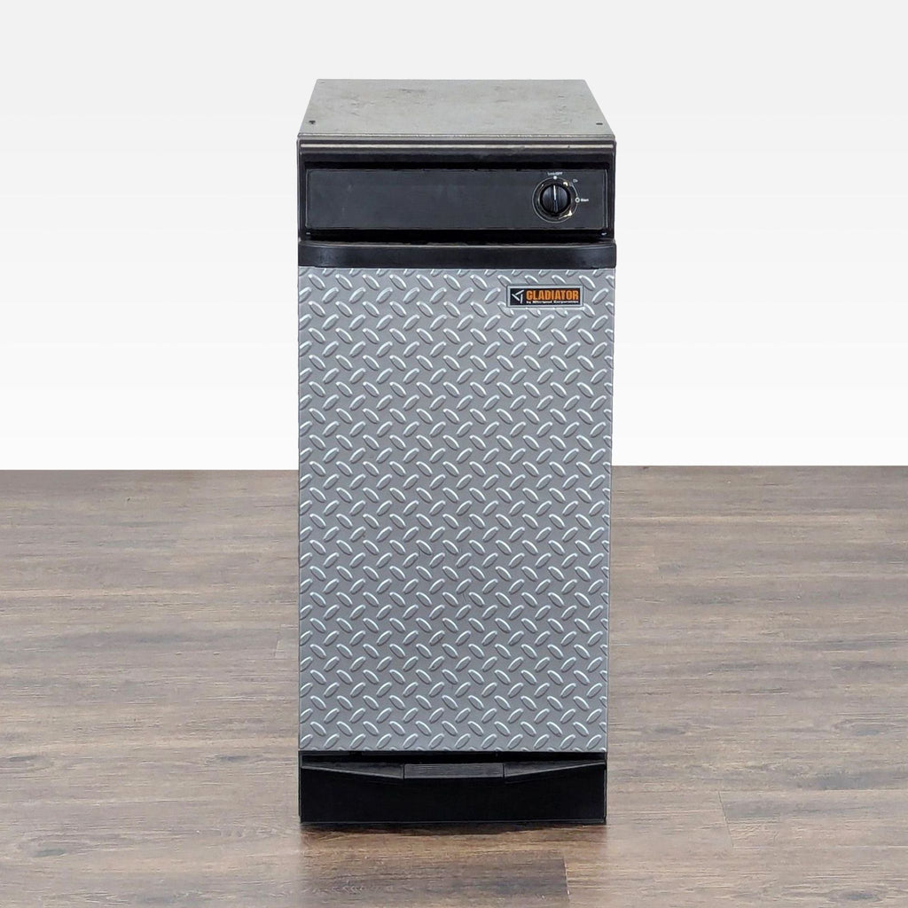 1. Front view of a Gladiator trash compactor with diamond plate panel and a black metal body, perfect for garages.