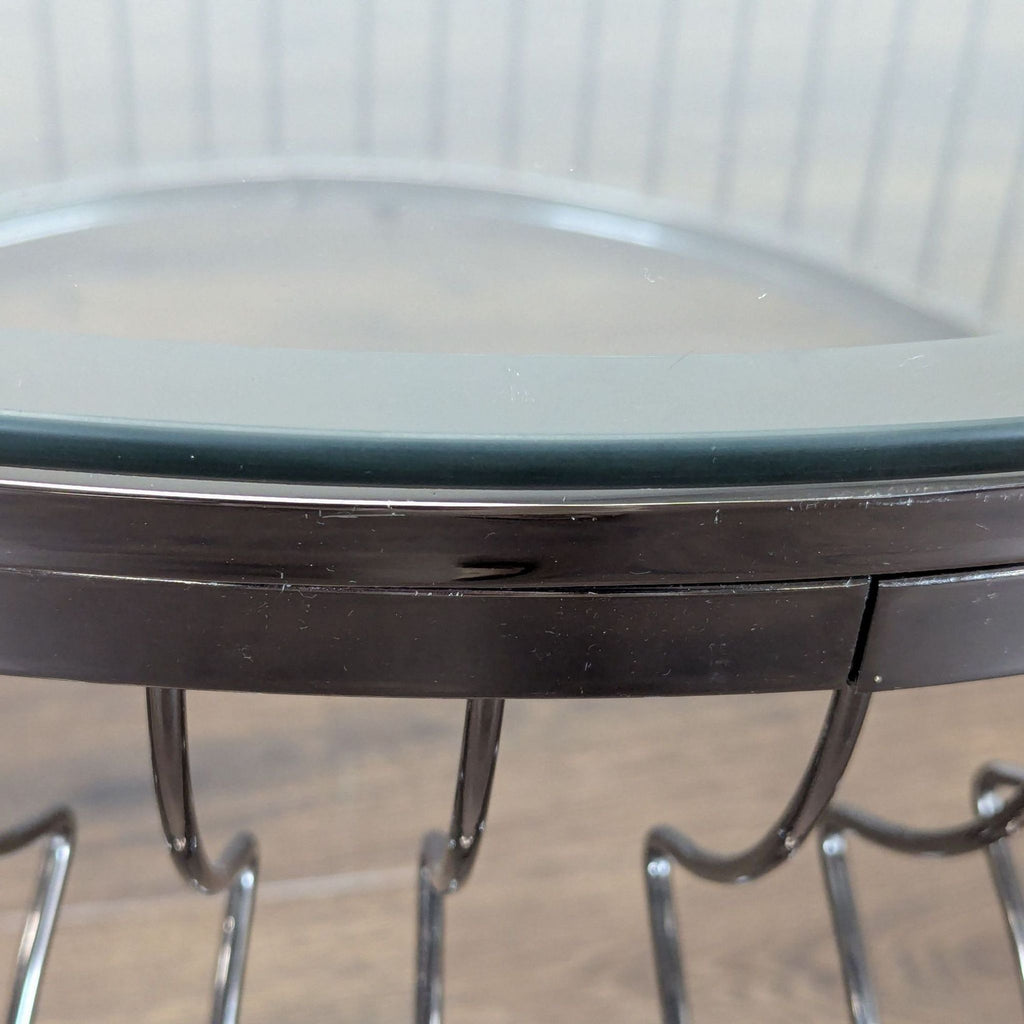 3. Close-up of the Reperch coffee table's glass top edge and sleek metal frame detail.