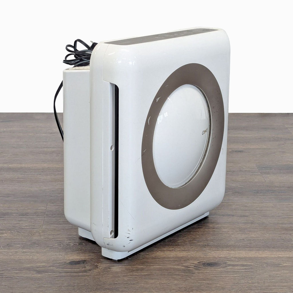 2. Side angle of a used Coway air purifier showing power cord and simple, modern design with signs of wear.
