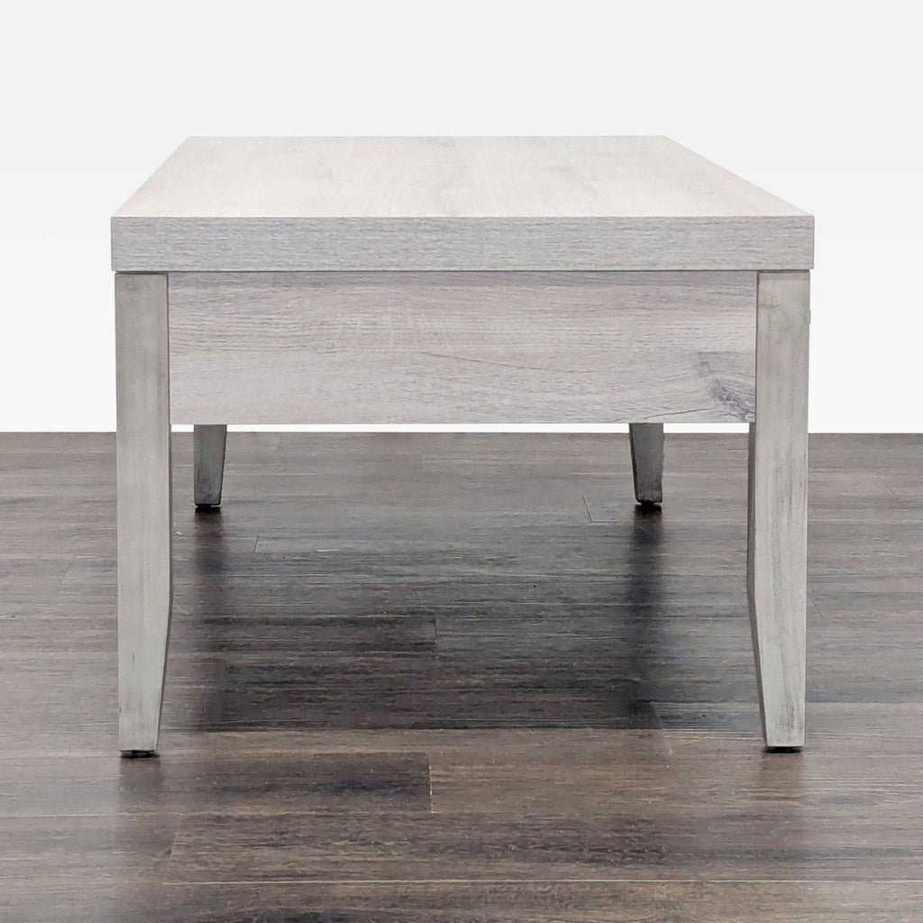 3. Side view of a light wood Hooker Furnishings coffee table, highlighting its minimalist design and sturdy legs.