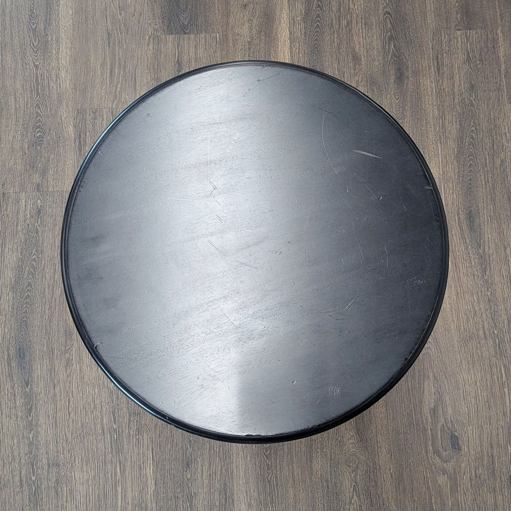 2. Top-down view of a round black end table from Reperch, highlighting its smooth, circular surface.  