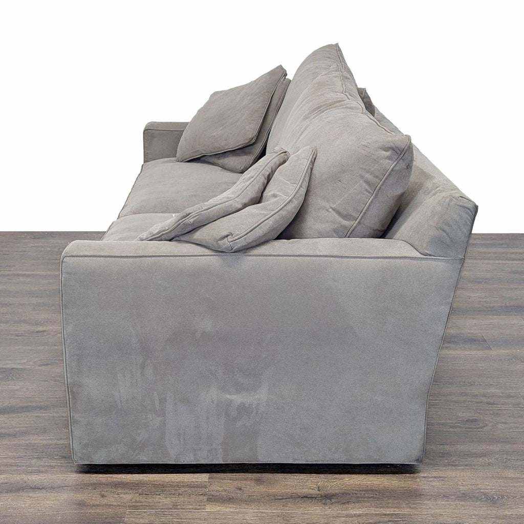 3. Side view of the soft gray Room & Board sleeper sofa, showcasing its clean lines and plush cushions.