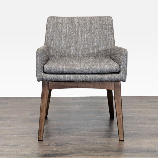 Front view of a modern Article lounge chair with grey upholstery and sturdy wooden legs, ideal for relaxing spaces.