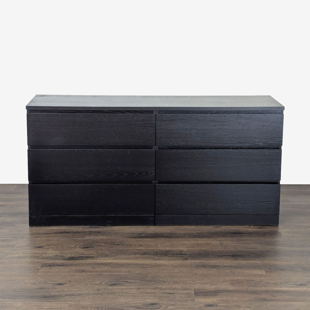 - Sleek black IKEA dresser with six drawers, modern design, ideal for bedroom or guest room storage.