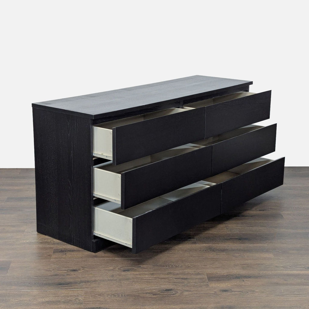 - Black six-drawer IKEA dresser shown partly open, highlighting spacious, easy-access storage compartments.