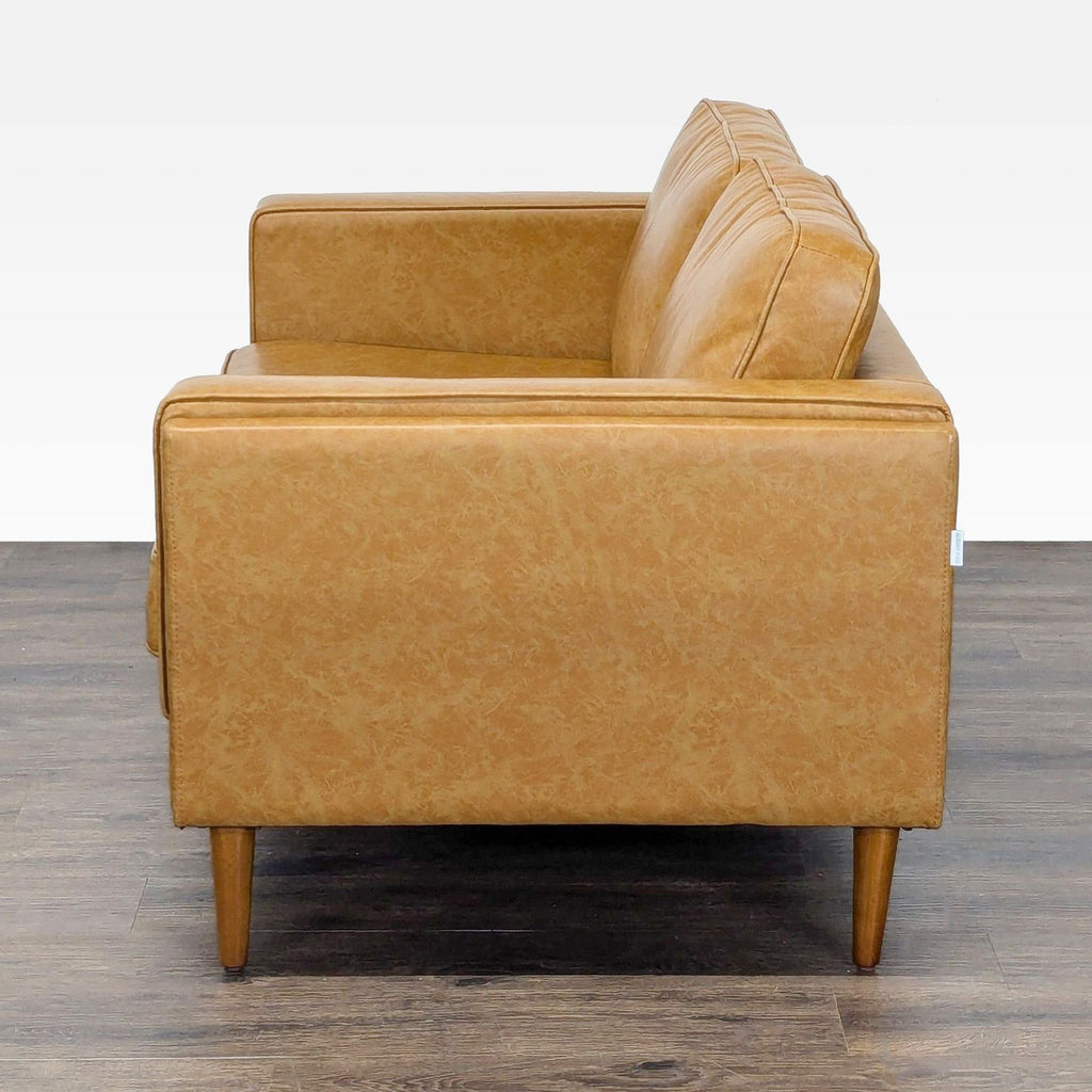 Albany Park tan loveseat with clean lines and wooden legs, perfect as an elegant accent piece.
