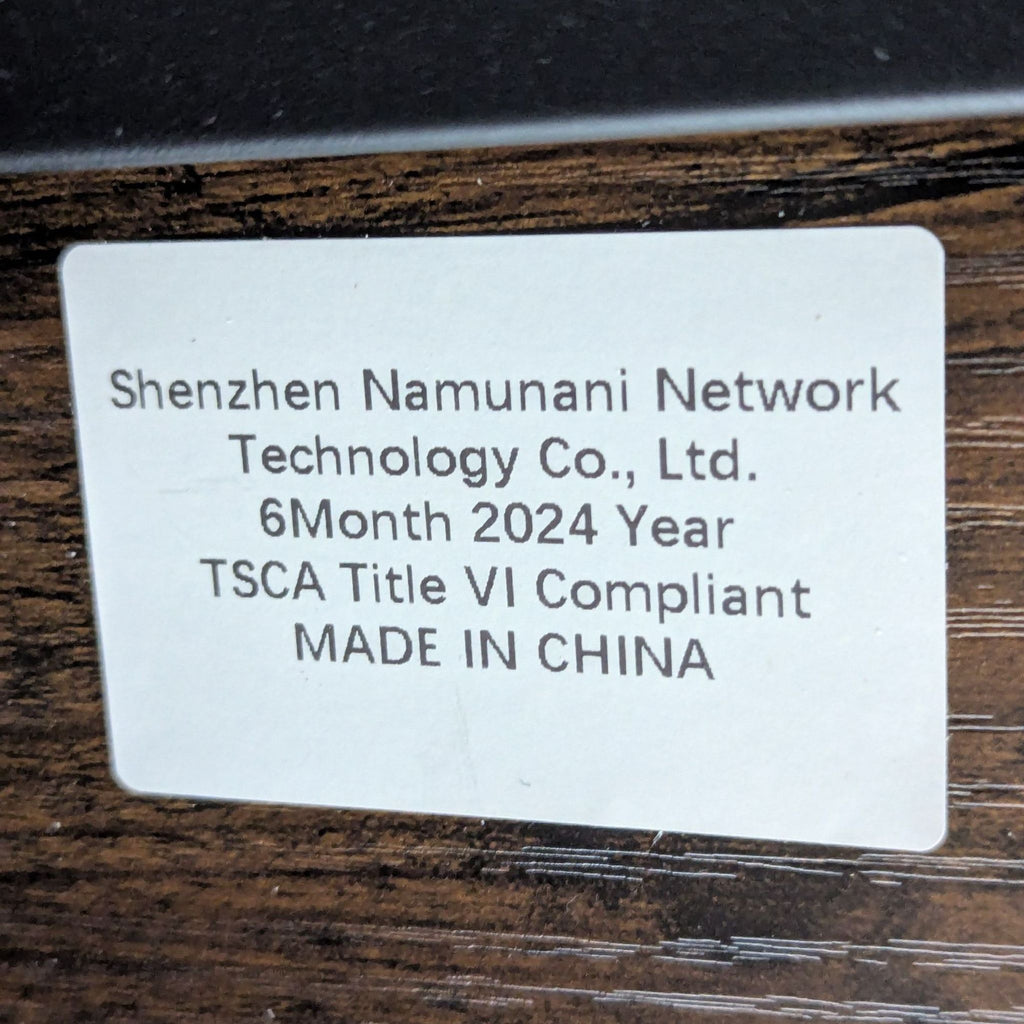 3. Product label on the Reperch console table stating manufacture details and compliance information.