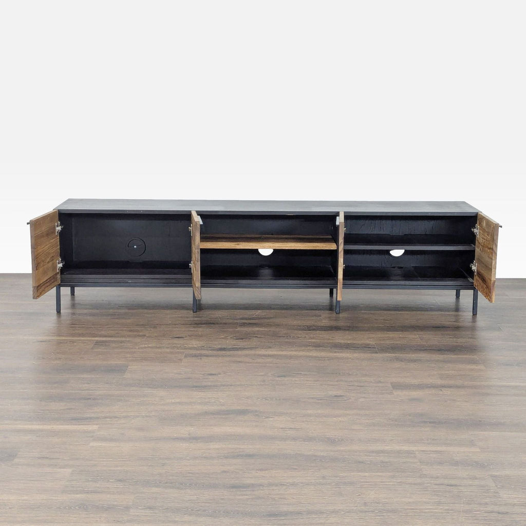 2. Entertainment center with open teak doors and shelves, black steel base, by Crate & Barrel, interior shown.