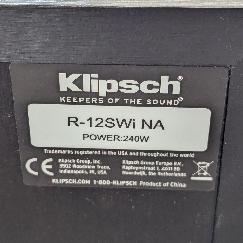 Close-up of the Klipsch R-12SWi NA subwoofer label, showing model and 240W power rating.