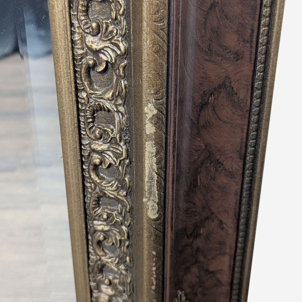 3. Detailed view of the Reperch mirror frame, highlighting the decorative gold patterns and an area with paint loss.