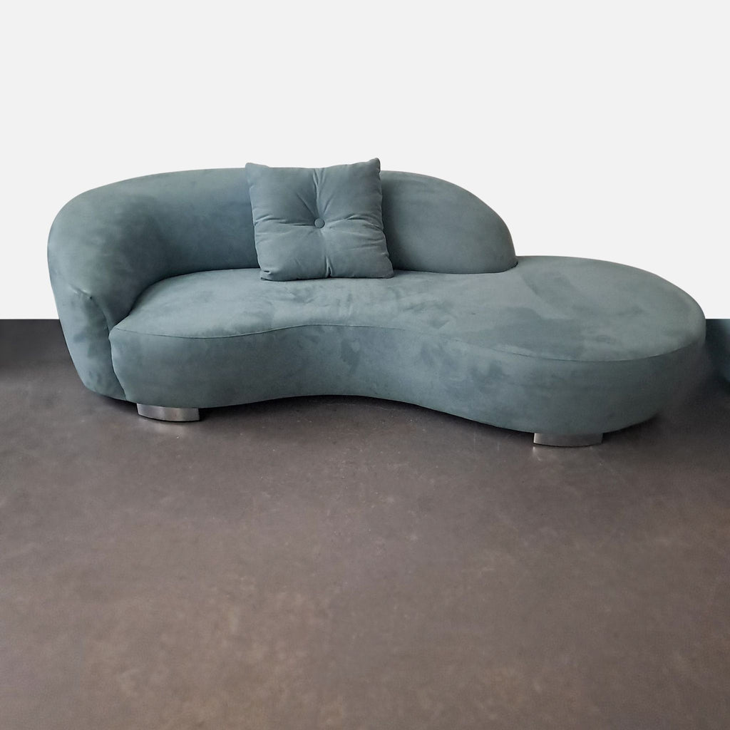 2. Close-up of stylish Lazar Industries sectional featuring plush fabric, curved design, silver legs, and a single pillow.  