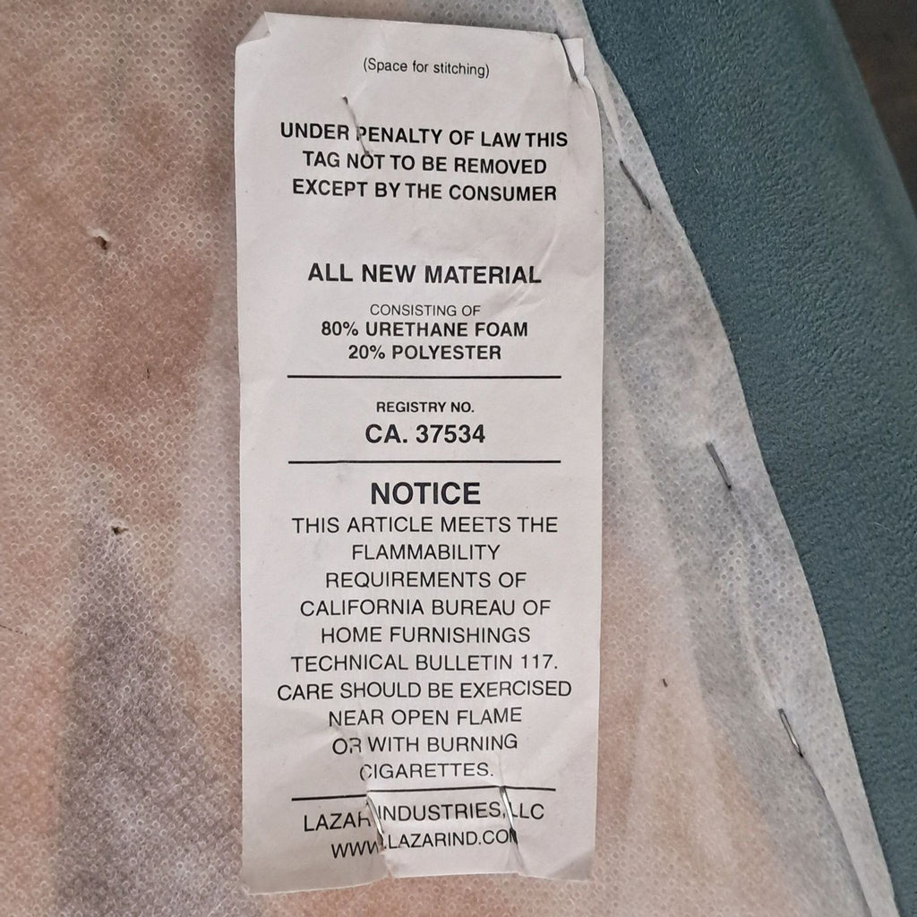 3. Manufacturer’s tag on a Lazar Industries sectional, detailing material content and flammability information.