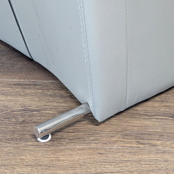 1. Close-up of a gray Reperch dining chair with metal legs on a wooden floor.