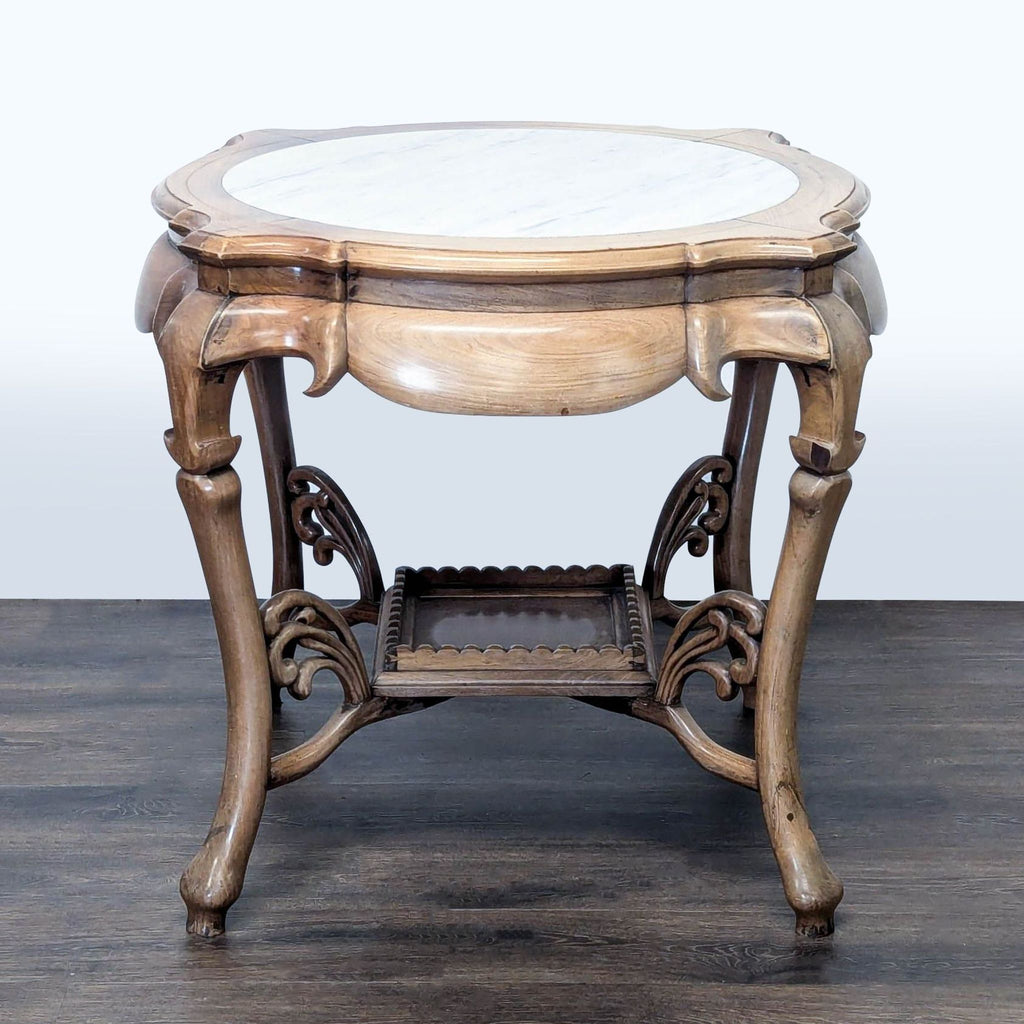 1. Ornate wooden Reperch end table with a round marble top and decorative lower shelf, shown against a pale background.  
