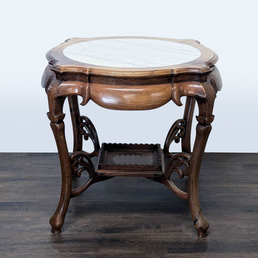 3. Vintage-inspired Reperch end table with elegant carvings, round marble surface, and dark sculpted lower shelf.