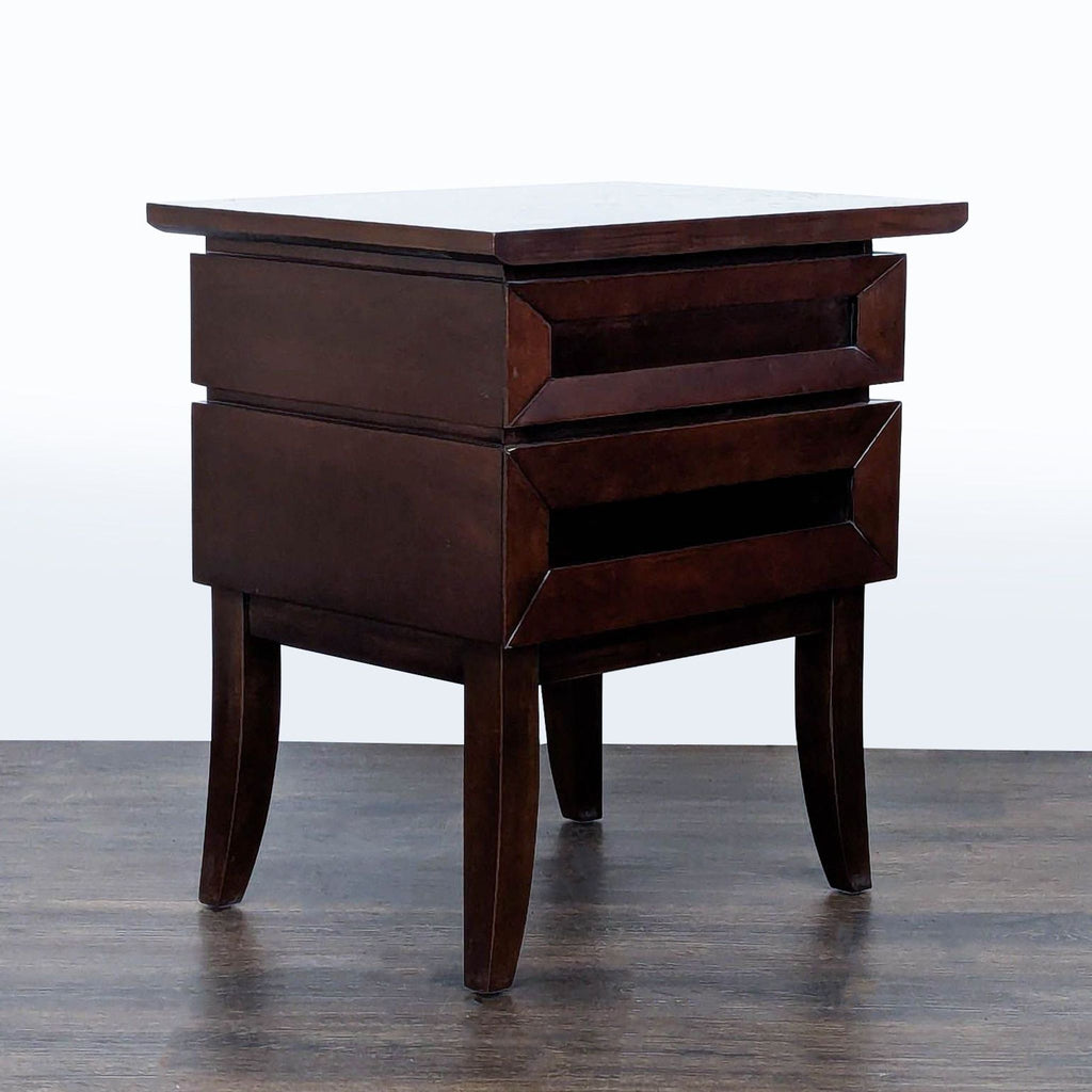 2. Angled side view of a Reperch end table showing its polished dark wood design and two front drawers.