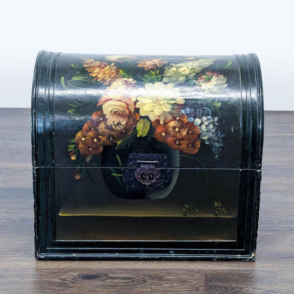 1. Black Reperch trunk with domed lid, decorated with colorful floral painting and metal lock on the front.  