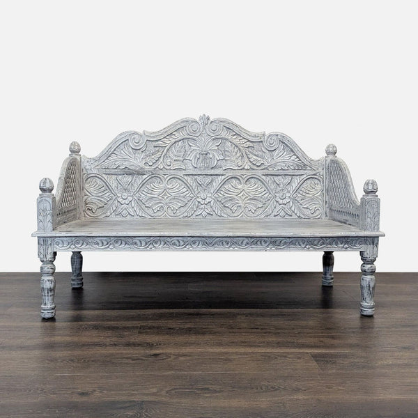 Hand-carved stool with whitewashed floral design, styled by Living Spaces.  