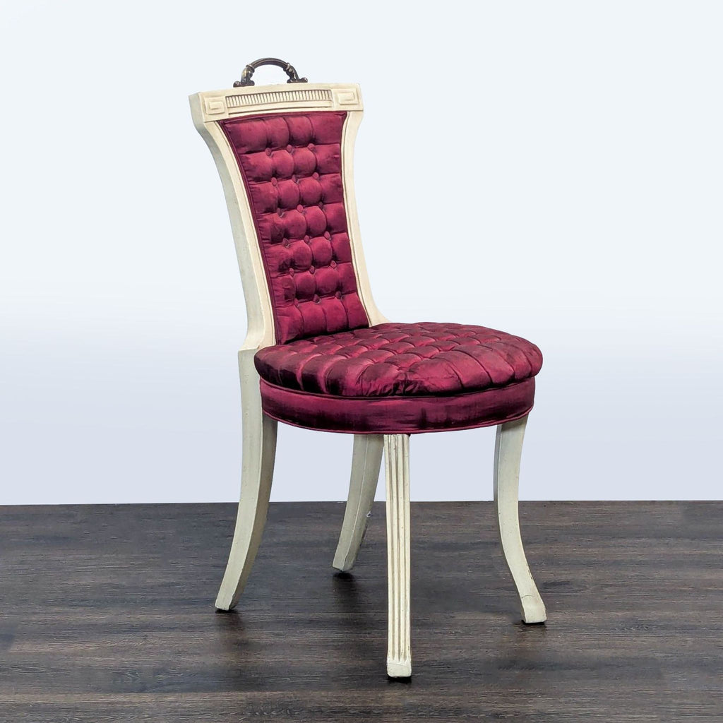 2. Angled view of a Reperch Lounge chair showing curved white legs and plush burgundy tufted upholstery.