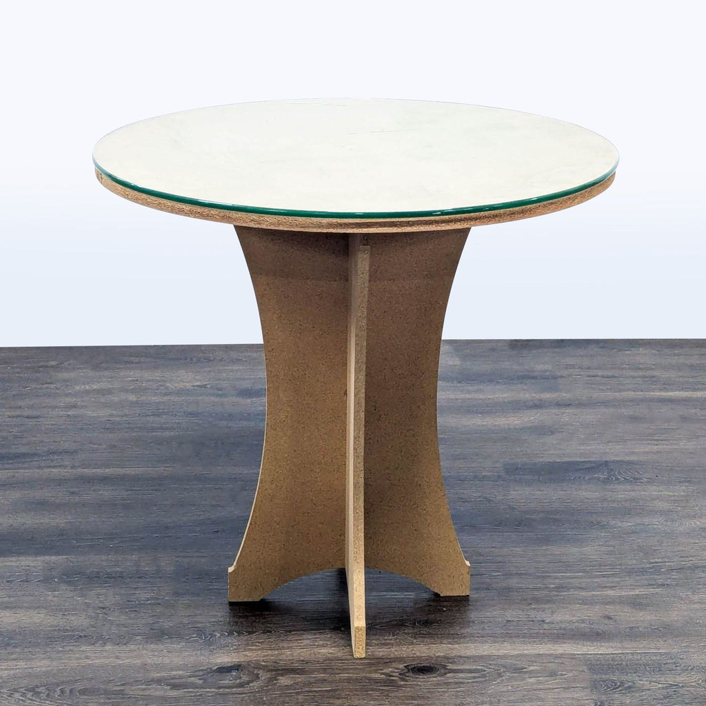 1. Round end table by Reperch with glass top and curved wooden base on dark wood floor.  