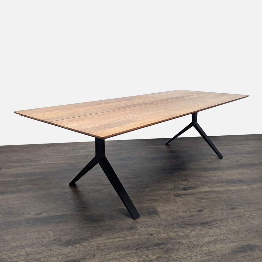 1. Modern De La Espada dining table with a rectangular wood top and black metal legs on dark wood flooring.