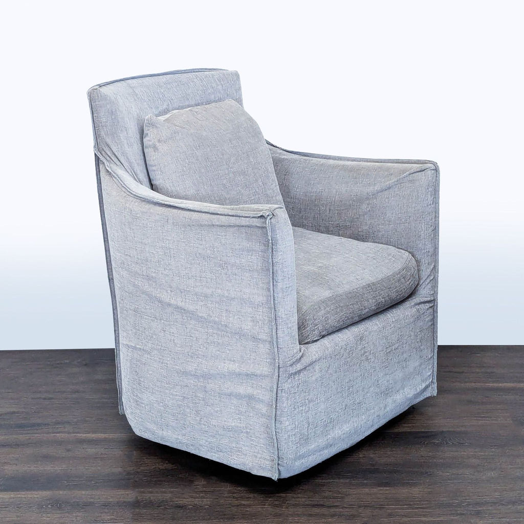 2. Angled side view of a soft gray lounge chair with plush seat and back cushion, Restoration Hardware brand.