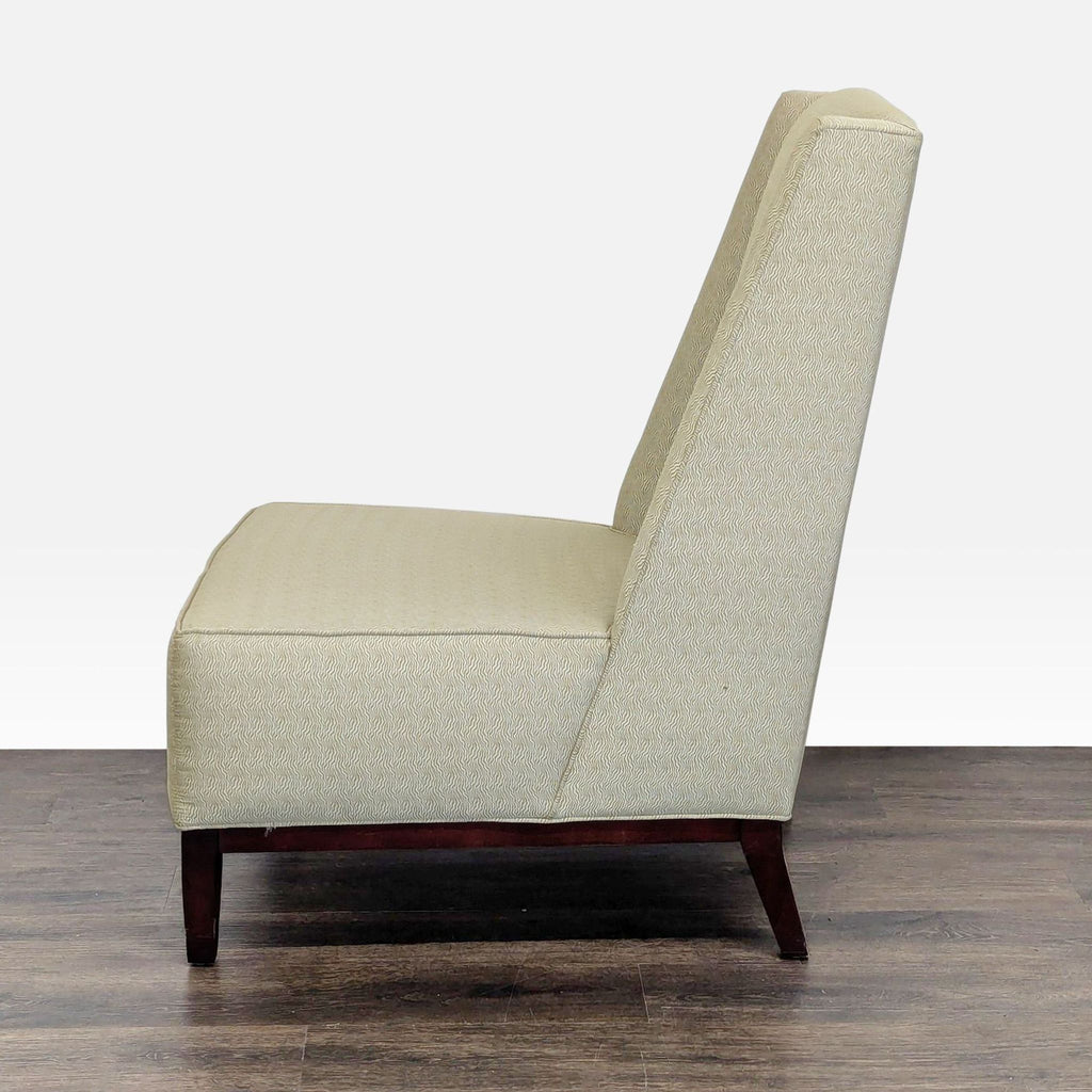 2. Side profile of a Reperch lounge chair featuring modern angles, pale fabric, and sturdy wood legs.