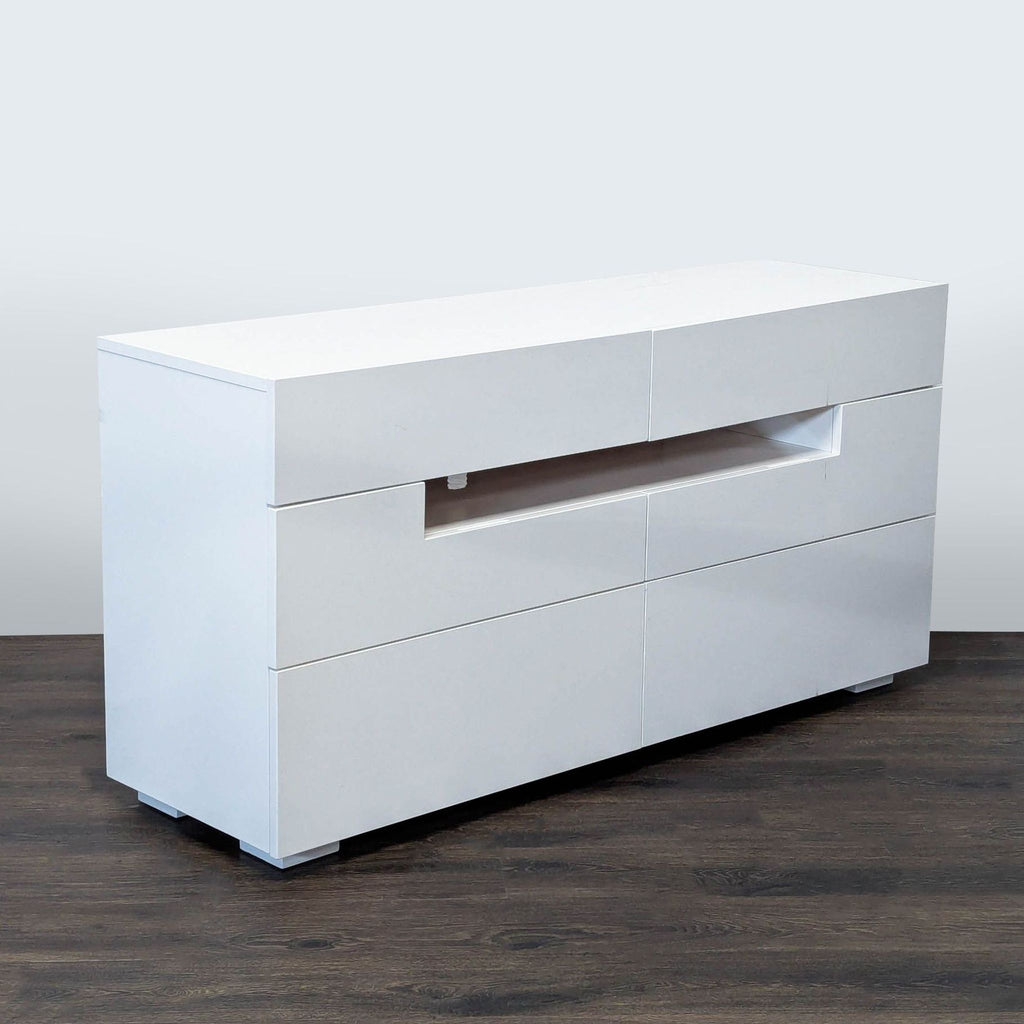 2. Modern white Reperch entertainment center with a sleek design and open shelf, shown from an angled side view.