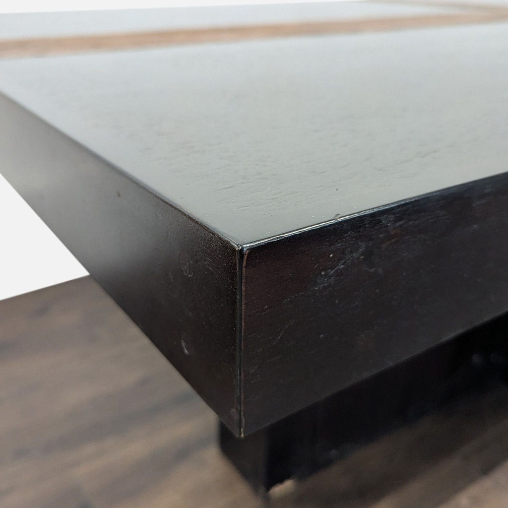 3. Angled view of the Reperch dining table's dark wood corner, showing its smooth finish and sturdy build.