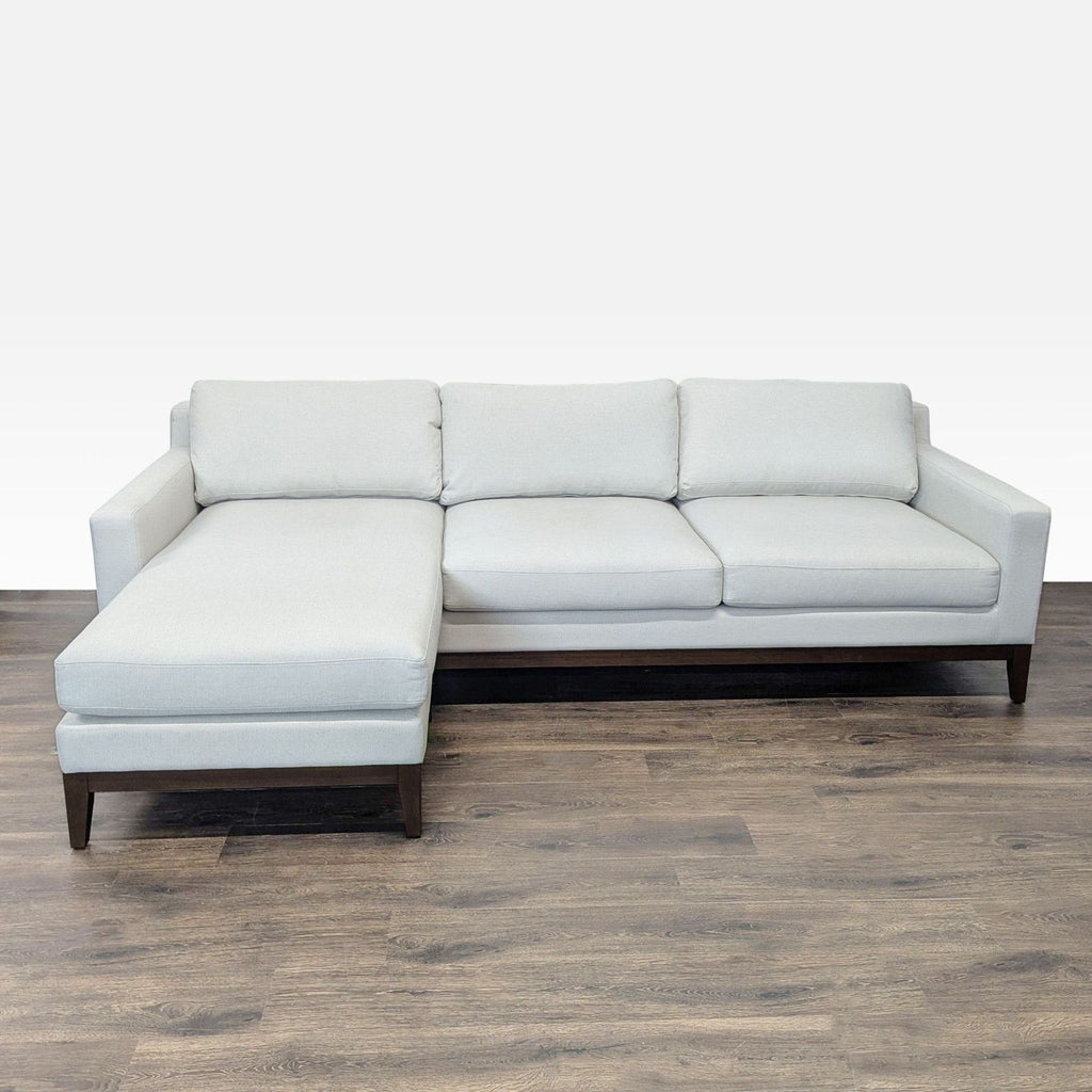 Poly & Bark sectional sofa with left-side chaise, gray fabric upholstery, and wooden legs in a modern style.