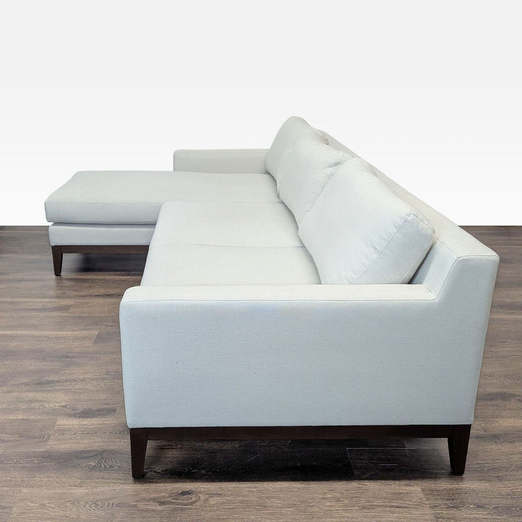 Contemporary fabric sectional by Poly & Bark, featuring a roomy chaise lounge and sturdy wood legs for added comfort.