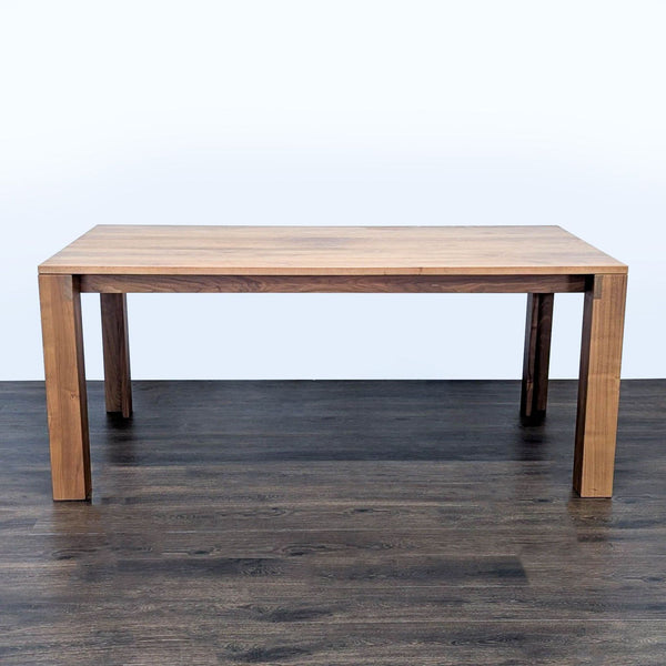 1. Rectangular wooden dining table by Design Within Reach with a simple, modern design, shown from front view.