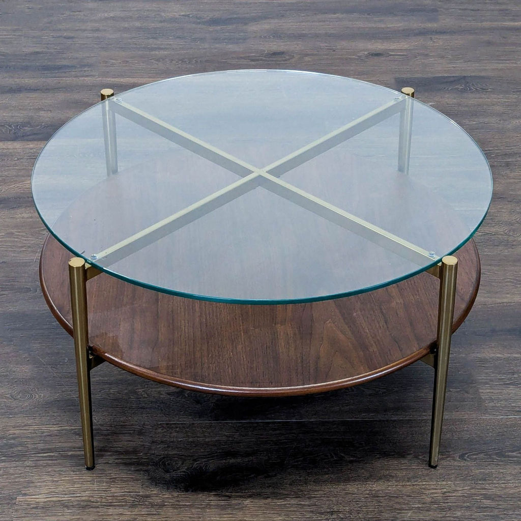 3. Overhead view of a Williams Sonoma coffee table, showing round glass top, brass supports, and wood shelf.