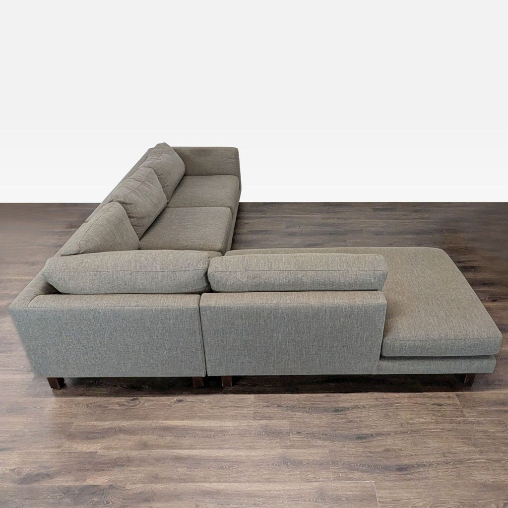Spacious Room & Board sectional sofa with clean lines, sturdy wood legs, and a stylish, contemporary appearance.