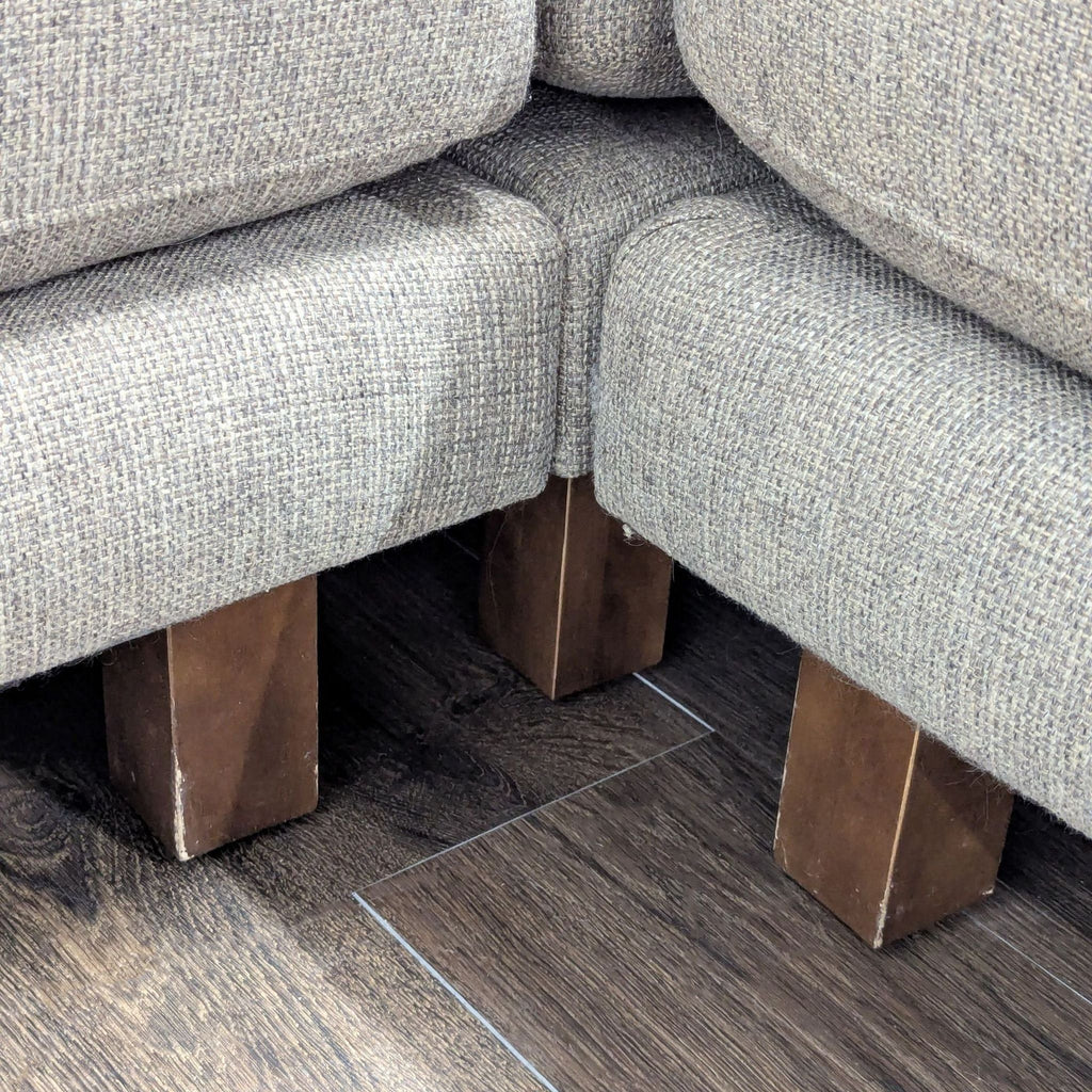 Contemporary sectional in neutral tones by Room & Board, featuring plush seating, chaise lounge, and wooden legs.