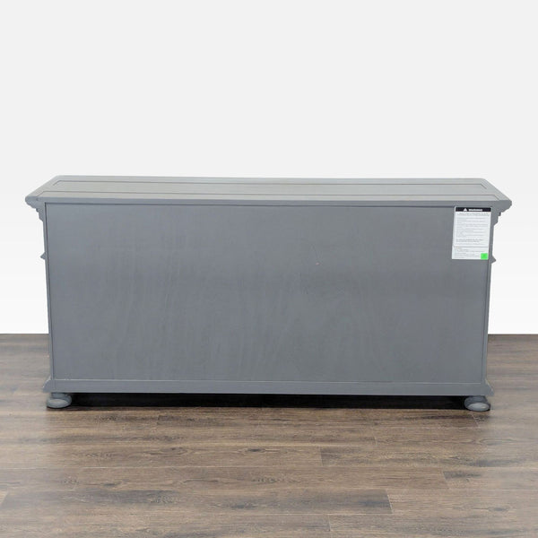 1. Gray Restoration Hardware dresser viewed from the back, showcasing a simple rectangular design and wooden legs.