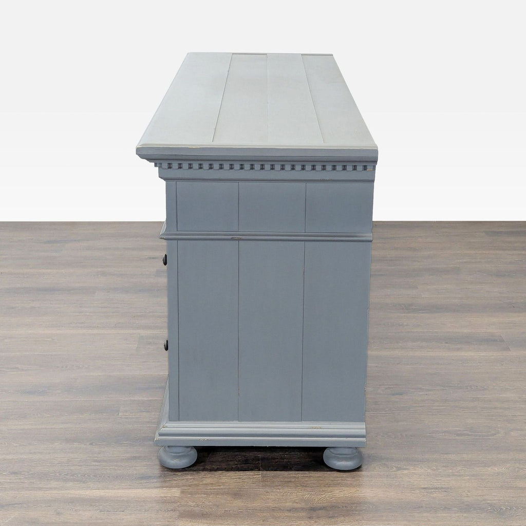 2. Side view of a Restoration Hardware dresser in gray, highlighting paneled sides and decorative trim detail.